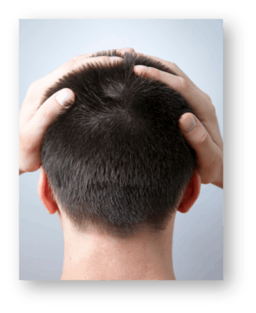 back view of a man with his hands on his head with hair.