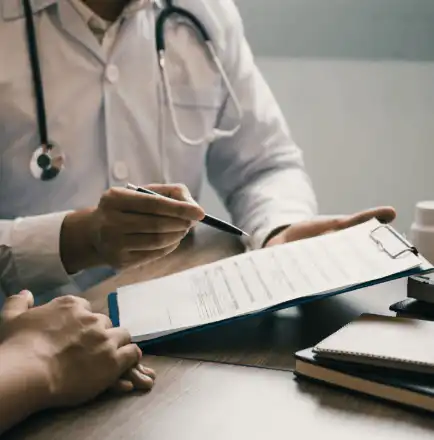 A doctor explaining a form to a patient during a consultation.